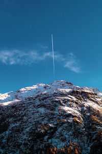 Scenic view of snowcapped mountains against clear blue sky