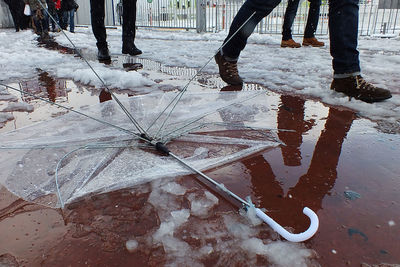 Low section of woman in puddle during winter