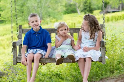 Siblings sitting on grass