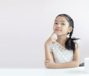 Portrait of a serious young woman over white background