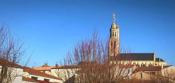 Low angle view of building against clear blue sky