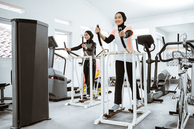 Side view of woman exercising in gym