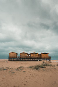 Built structure on beach against sky
