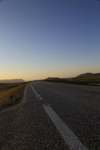 Surface level of road against clear sky