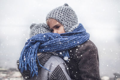 Portrait of smiling young woman in warm clothes