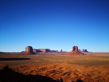 View of desert against clear blue sky