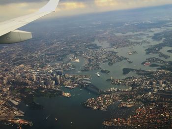 Aerial view of airplane flying over cityscape