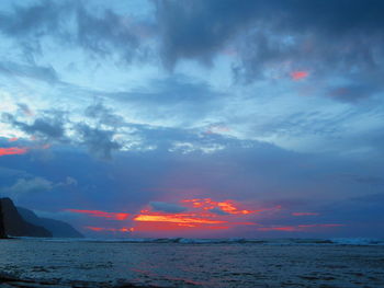 Scenic view of sea against dramatic sky during sunset