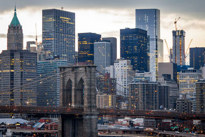 Modern buildings in city against cloudy sky