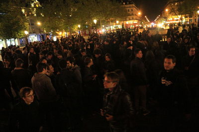 Crowd at illuminated city at night