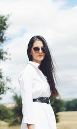 Pretty girl with shirt and sunglasses in the field