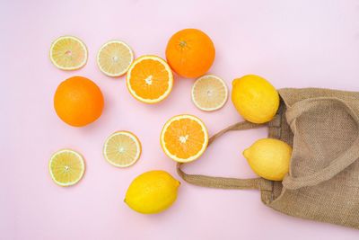 High angle view of lemon and orange on white background