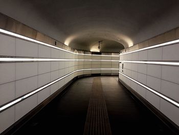 Low angle view of illuminated underground walkway