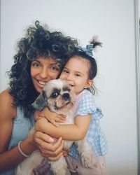 Portrait of woman with dog holding camera
