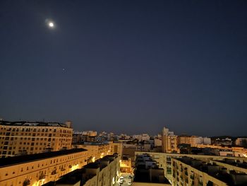 High angle view of illuminated buildings against sky at night