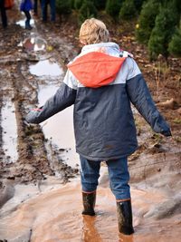 Rear view of a boy walking