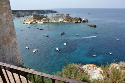 High angle view of rocks on sea shore against sky