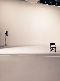 Empty chair and lighting equipment at film set