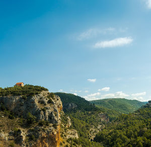 Scenic view of mountains against blue sky