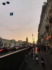 People on street amidst buildings in city