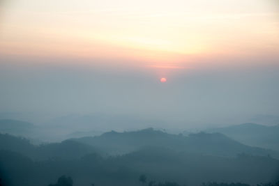 Scenic view of silhouette mountains against sky during sunset