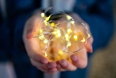 Close-up of hand holding crystal ball