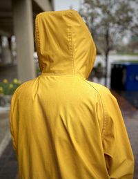Rear view of woman wearing raincoat 