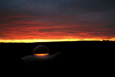 Scenic view of dramatic sky at sunset