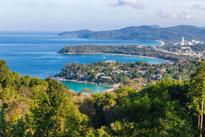 High angle view of townscape by sea against sky