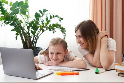 Mother helping daughter with homework