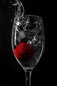 Close-up of wine glass against black background