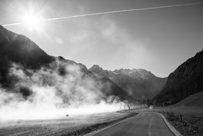 Road amidst mountains against sky