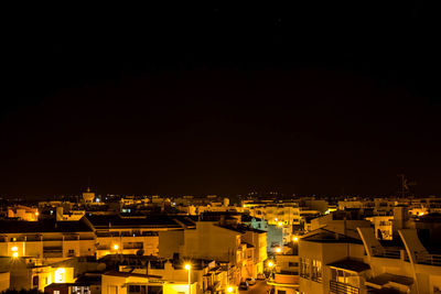 High angle view of illuminated buildings in city at night