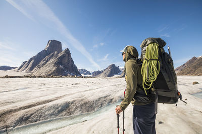 Backpacker looks up towards his next objective, mount asgard, canada.