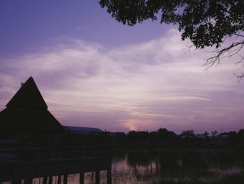 Silhouette of temple against sky at sunset