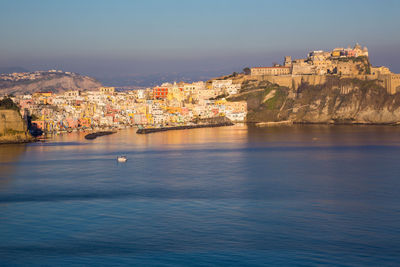 Town by sea against sky in city