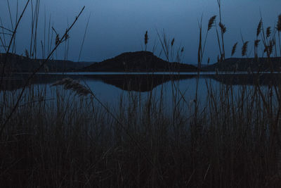 Scenic view of lake against sky at dusk