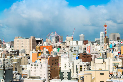 Cityscape against cloudy sky