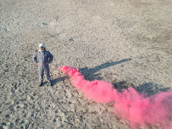 High angle view of man standing by distress flare on ground