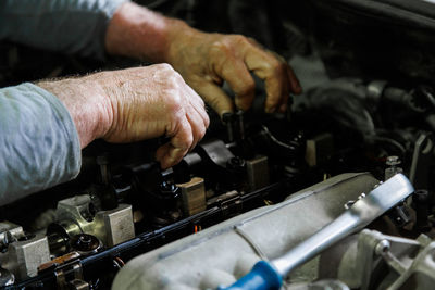 Midsection of man repairing car