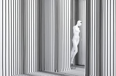 Mannequin by striped wall