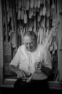 Senior man with work tools in workshop