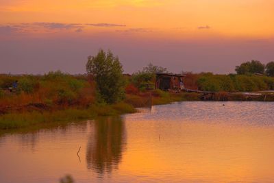 Scenic view of lake against orange sky