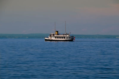 Ship sailing in sea against sky