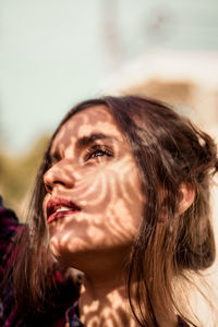 Close-up of young woman looking away