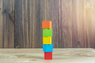 Multi colored toy on table against wall