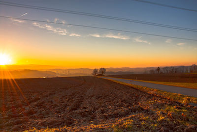 Scenic view of field against sky during sunset