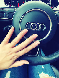 Close-up of human hand in car