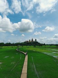 Scenic view of land against cloudy sky