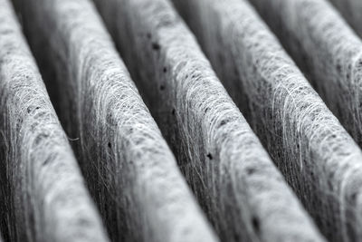 A macro shot of the surface rectangular, carbon cabin filter. fibers arranged in diagonal lines.